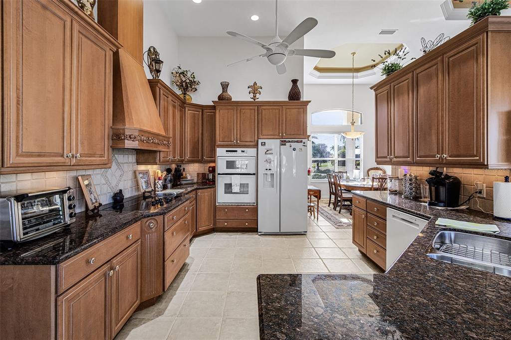 400 Gun Cay Lane Punta Gorda, FL 33950 - Photo 13 of 50 a kitchen with stainless steel appliances granite countertop a refrigerator a stove and a sink