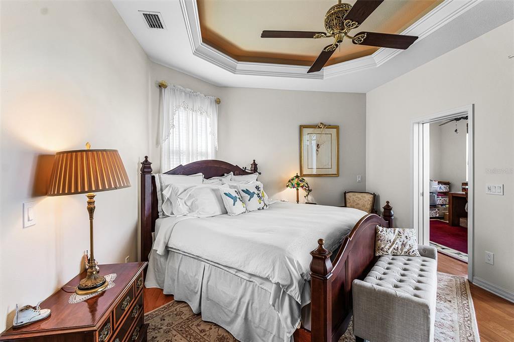 400 Gun Cay Lane Punta Gorda, FL 33950 - Photo 17 of 50 a bedroom with a bed and a dresser with wooden floor