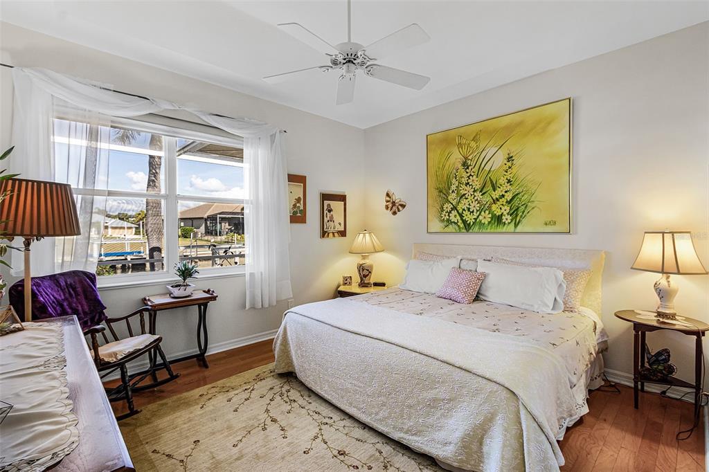 400 Gun Cay Lane Punta Gorda, FL 33950 - Photo 24 of 50 a bedroom with a bed a large window with table and chairs