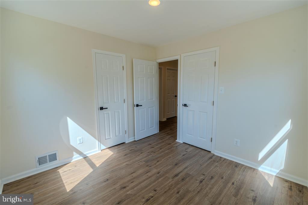 12324 Centerhill Street Silver Spring, MD 20902 - Photo 14 of 24 a view of an empty room with wooden floor