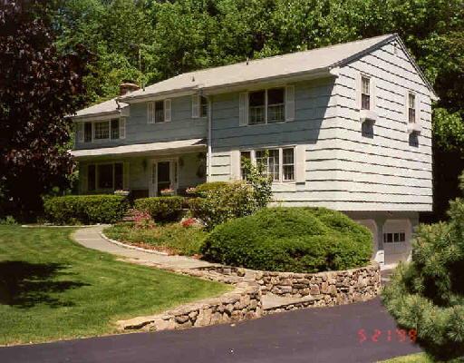 121 Holmes Road Ridgefield, CT 06877 - Photo 1 of 1 a front view of a house with a yard