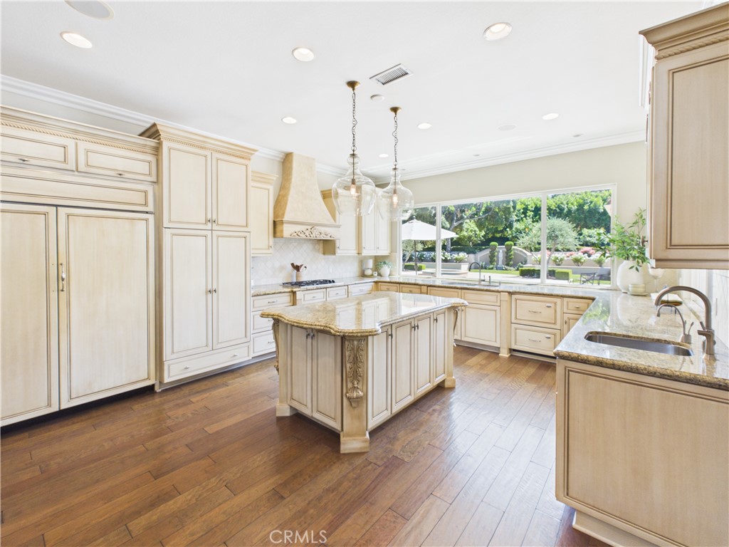 1662 Cherokee Road Corona, CA 92881 - Photo 19 of 60 a kitchen with kitchen island granite countertop a sink appliances and cabinets