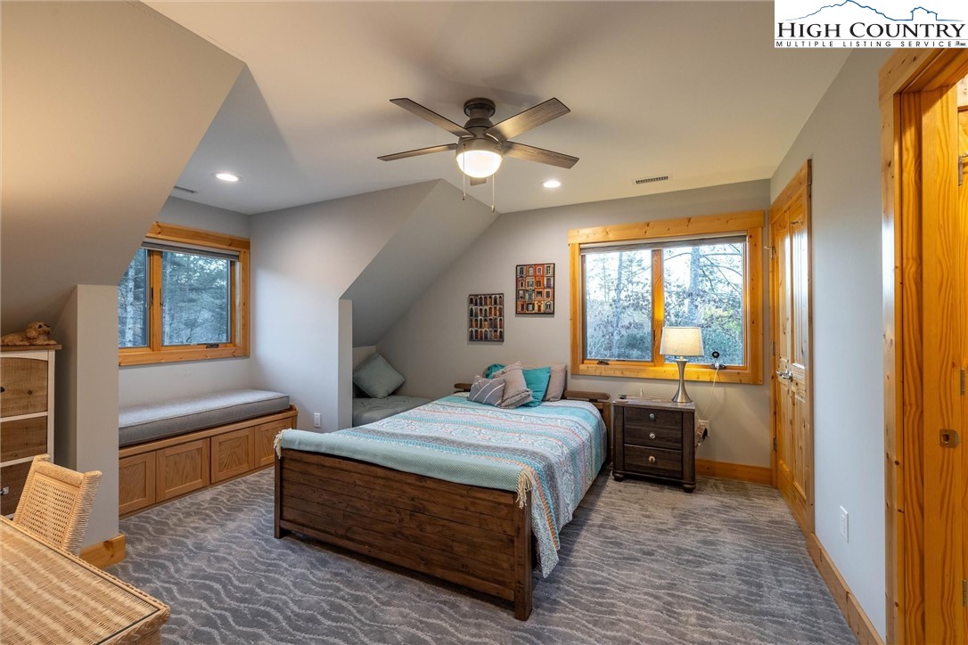 1989 Johns Ridge Parkway Lenoir, NC 28645 - Photo 21 of 50 a bedroom with a large bed and a chandelier