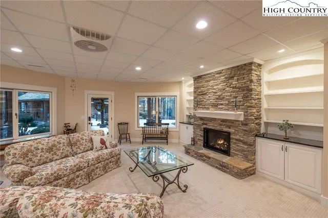 a large kitchen with kitchen island a sink a center island a stove and a chandelier