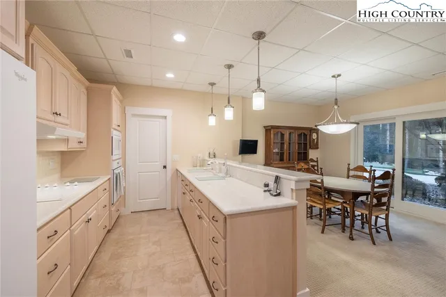 a spacious bedroom with a large bed and a dresser