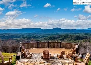 a sign that is sitting in the grass near a tree