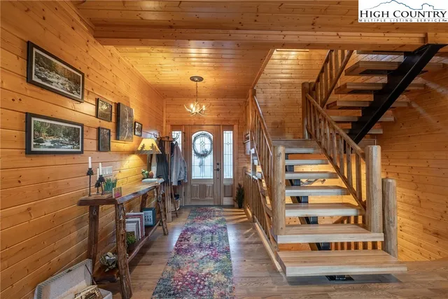 a living room with furniture fireplace and a large window