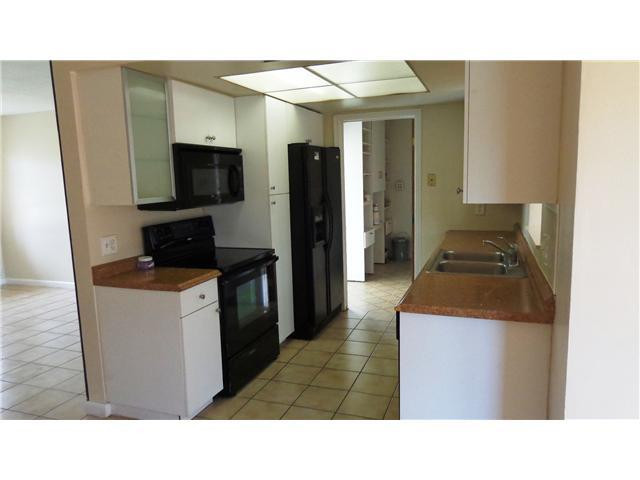 161 Northeast 20th Street Pompano Beach, FL 33060 - Photo 4 of 10 a kitchen with a sink and stainless steel appliances