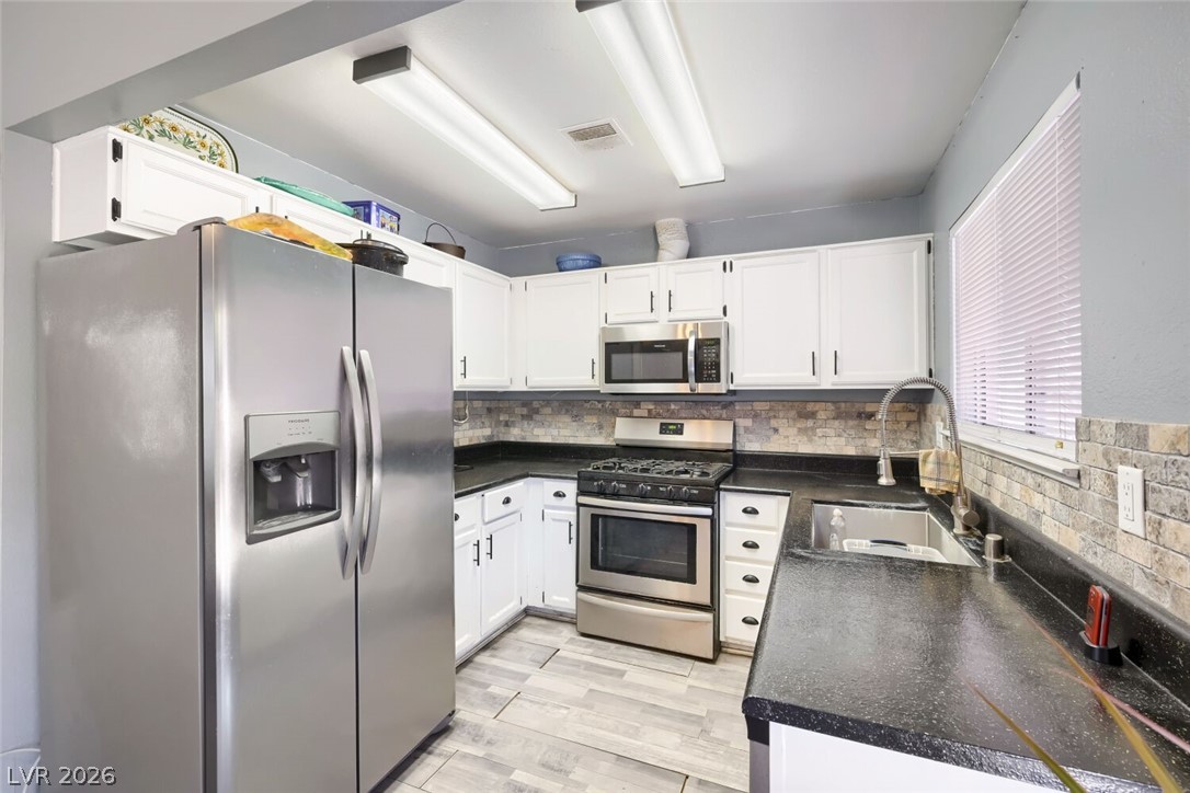 2322 Sabroso Street Las Vegas, NV 89156 - Photo 7 of 17 A well-lit kitchen with stainless finish appliances.