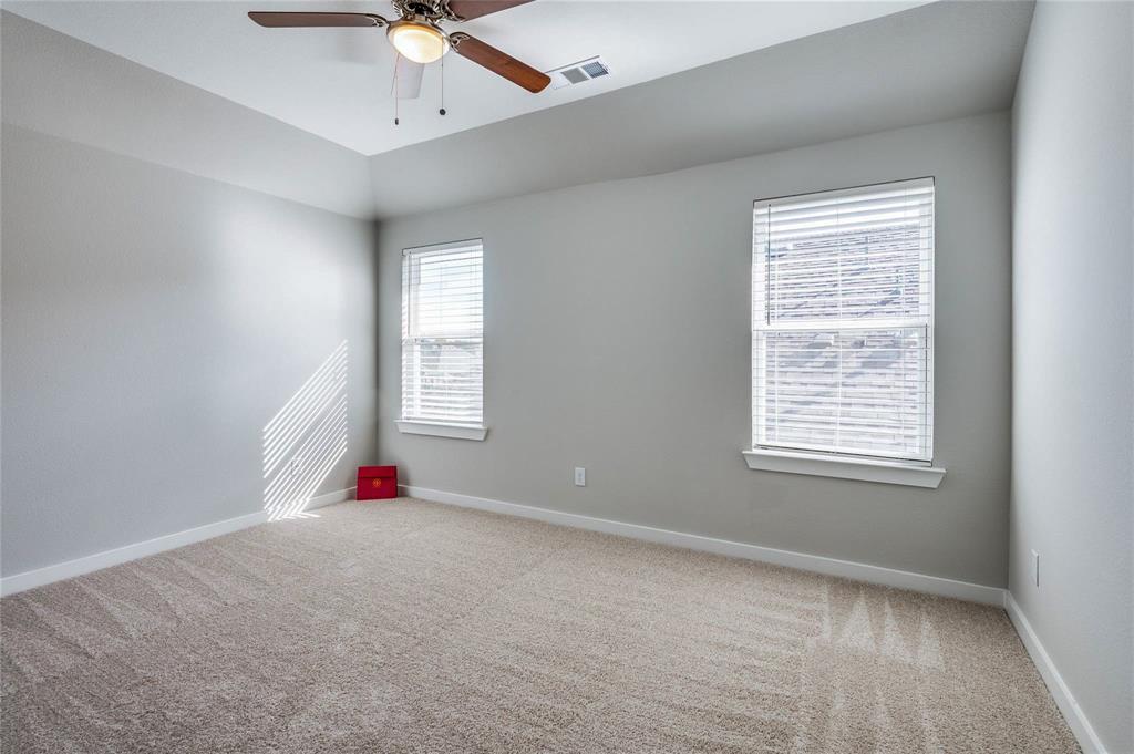 1309 Old Rocksprings Pass Mansfield, TX 76063 - Photo 24 of 36 Carpeted room featuring a tray ceiling, ceiling fan with light, two windows with blinds, and light gray walls