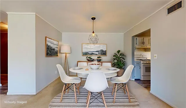 a dining room with furniture a chandelier and wooden floor
