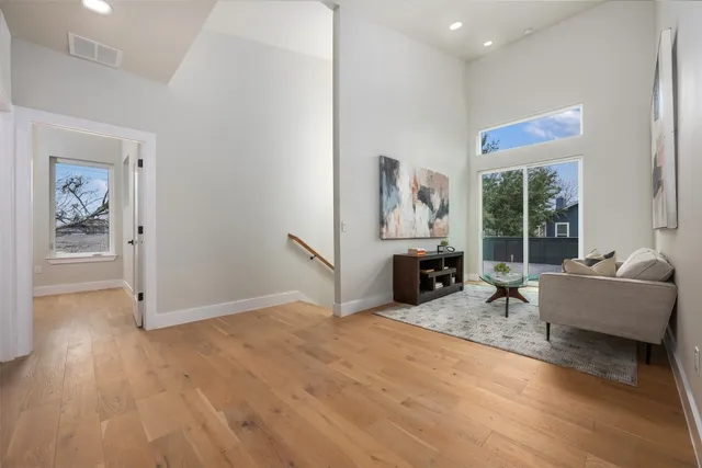 a living room with furniture a fireplace and a floor to ceiling window