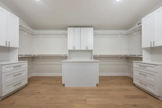 a kitchen with white cabinets and a refrigerator