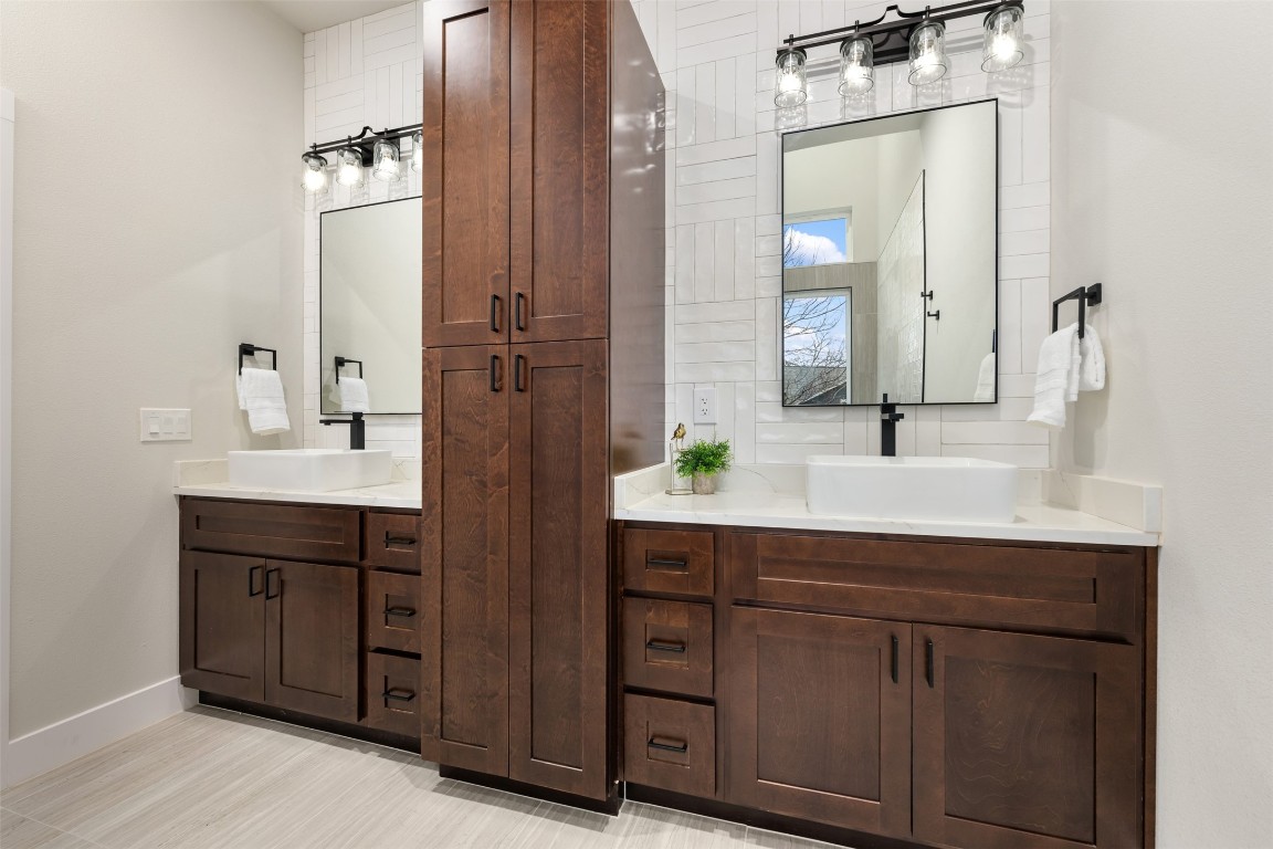 1004 Karen Avenue Austin, TX 78757 - Photo 18 of 29 a bathroom with a double vanity sink and a mirror