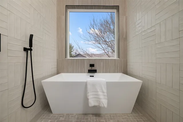 a white bath tub sitting in a bathroom