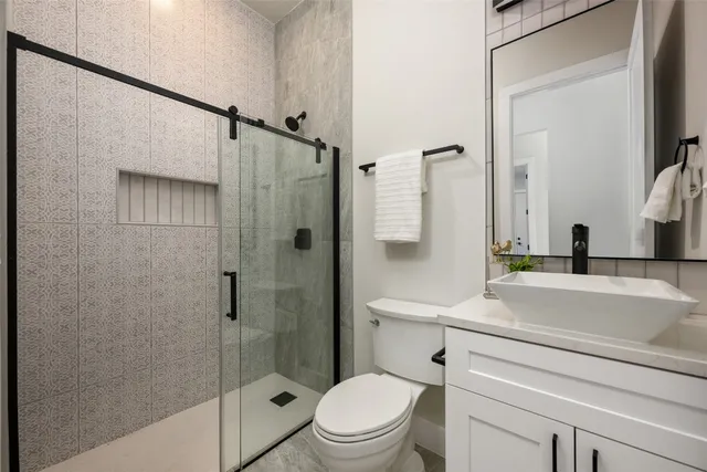 a bathroom with a sink a toilet and a mirror