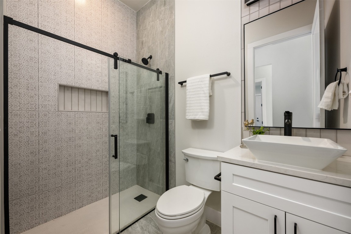 1004 Karen Avenue Austin, TX 78757 - Photo 23 of 29 a bathroom with a sink a toilet and a mirror