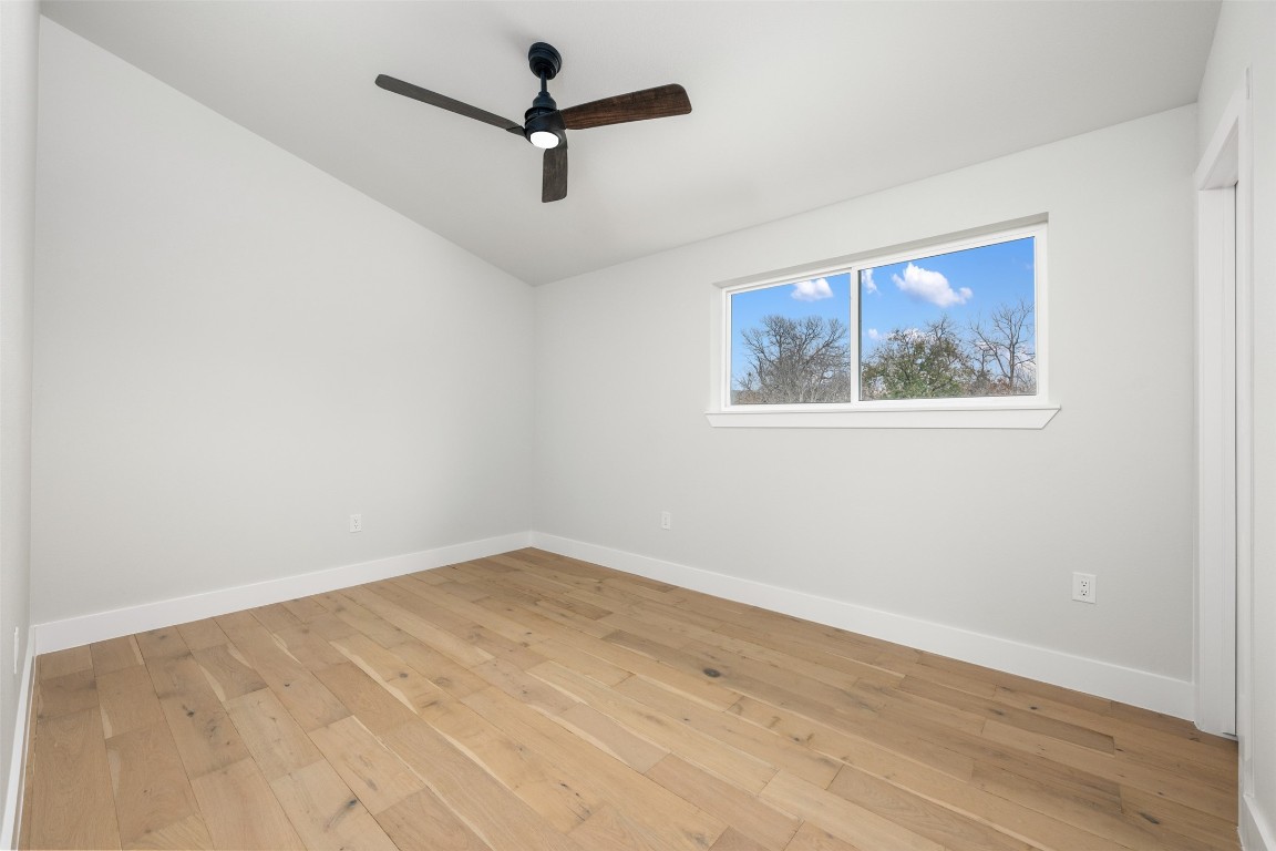 1004 Karen Avenue Austin, TX 78757 - Photo 24 of 29 an empty room with wooden floor and ceiling fan