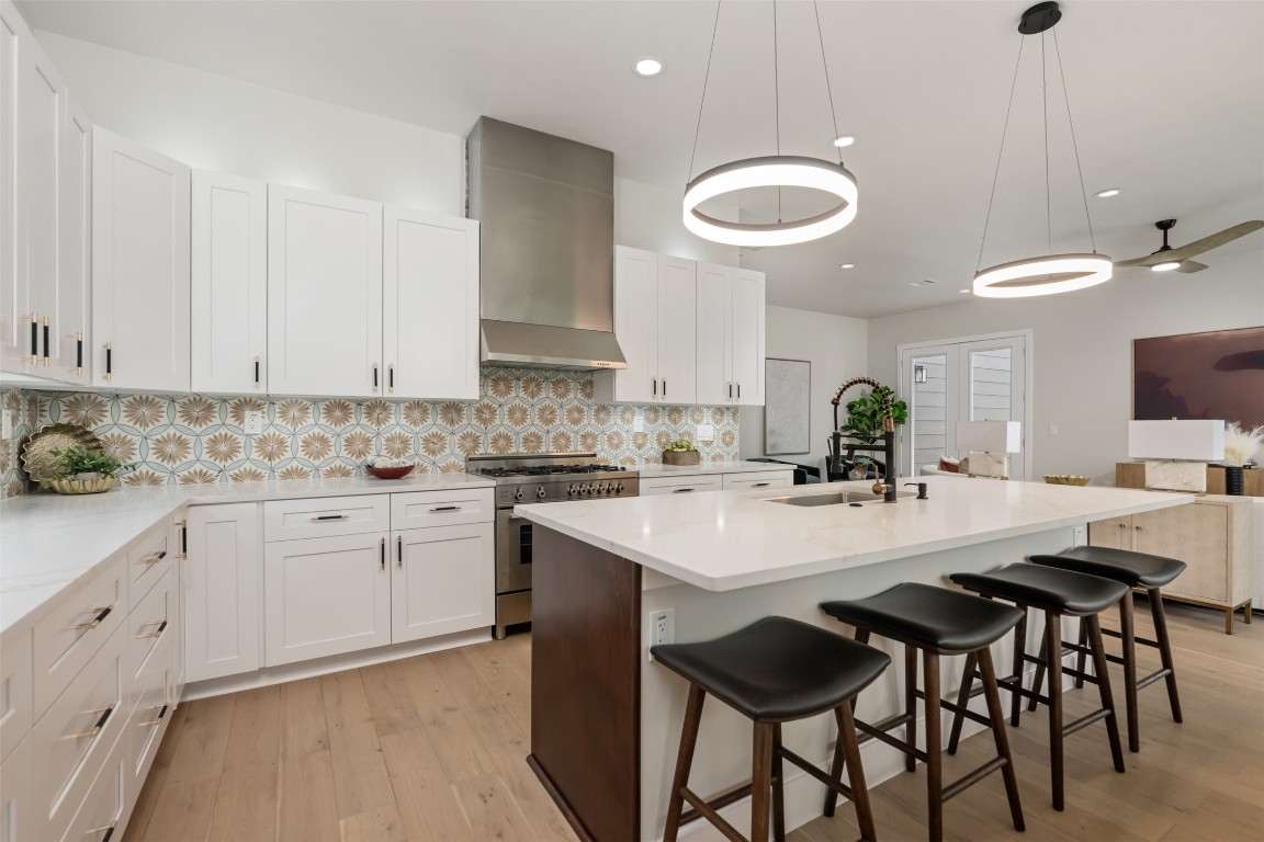 1004 Karen Avenue Austin, TX 78757 - Photo 4 of 29 a kitchen with a dining table chairs sink and cabinets