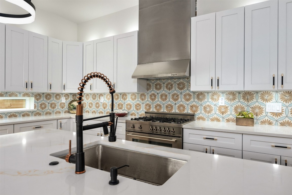 1004 Karen Avenue Austin, TX 78757 - Photo 6 of 29 a kitchen with stainless steel appliances granite countertop a stove and a white cabinets
