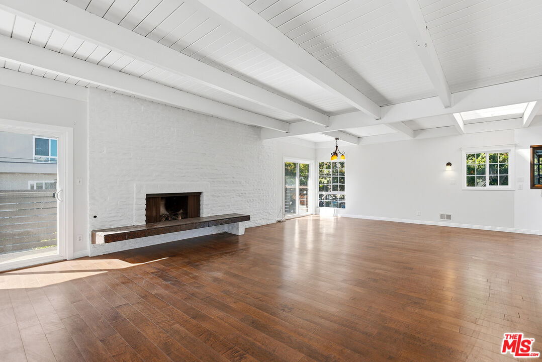 3900 Pacific Avenue Marina del Rey, CA 90292 - Photo 11 of 65 an empty room with wooden floor and fireplace