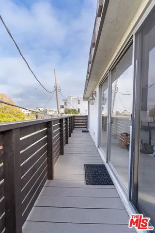 a view of a balcony with wooden floor