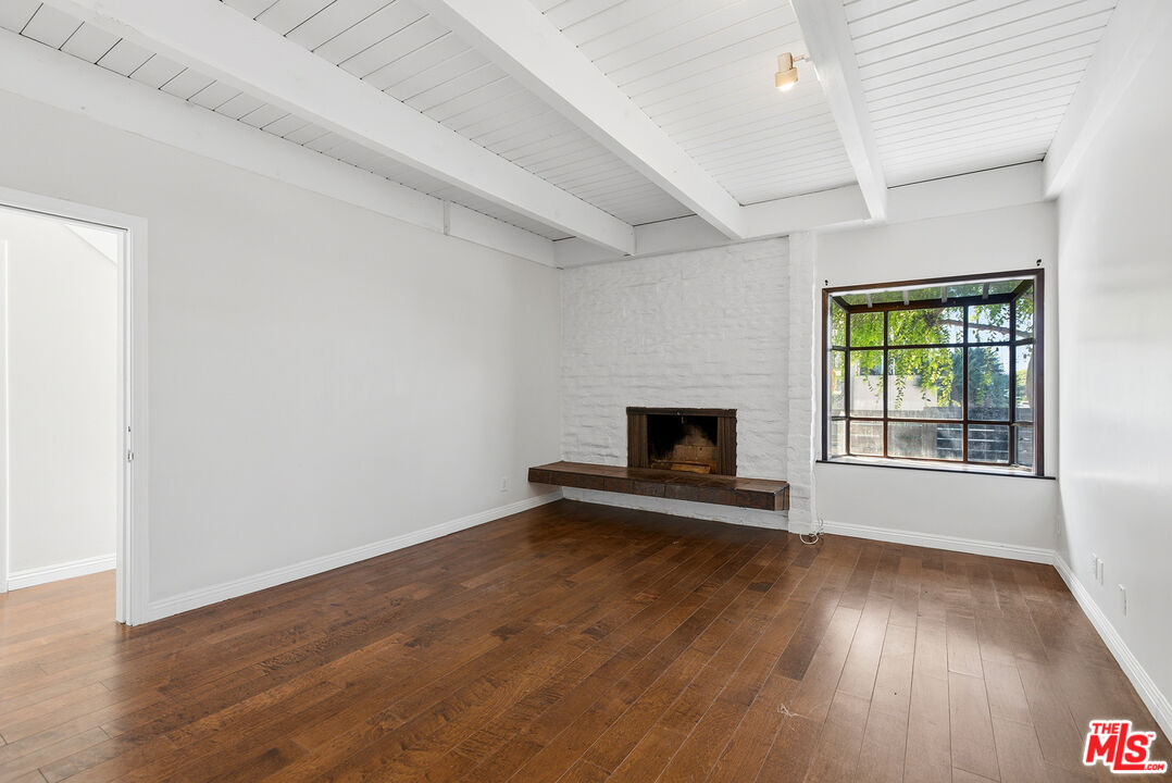 3900 Pacific Avenue Marina del Rey, CA 90292 - Photo 21 of 65 an empty room with wooden floor fireplace and windows