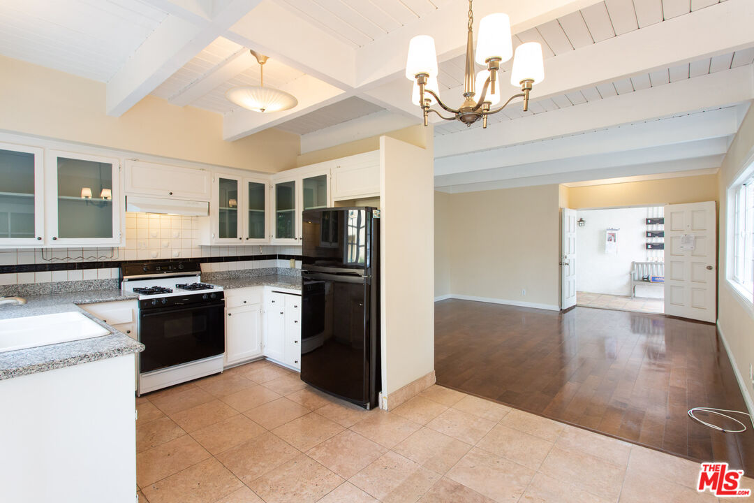 3900 Pacific Avenue Marina del Rey, CA 90292 - Photo 37 of 65 a kitchen with stainless steel appliances granite countertop a stove a sink and a refrigerator