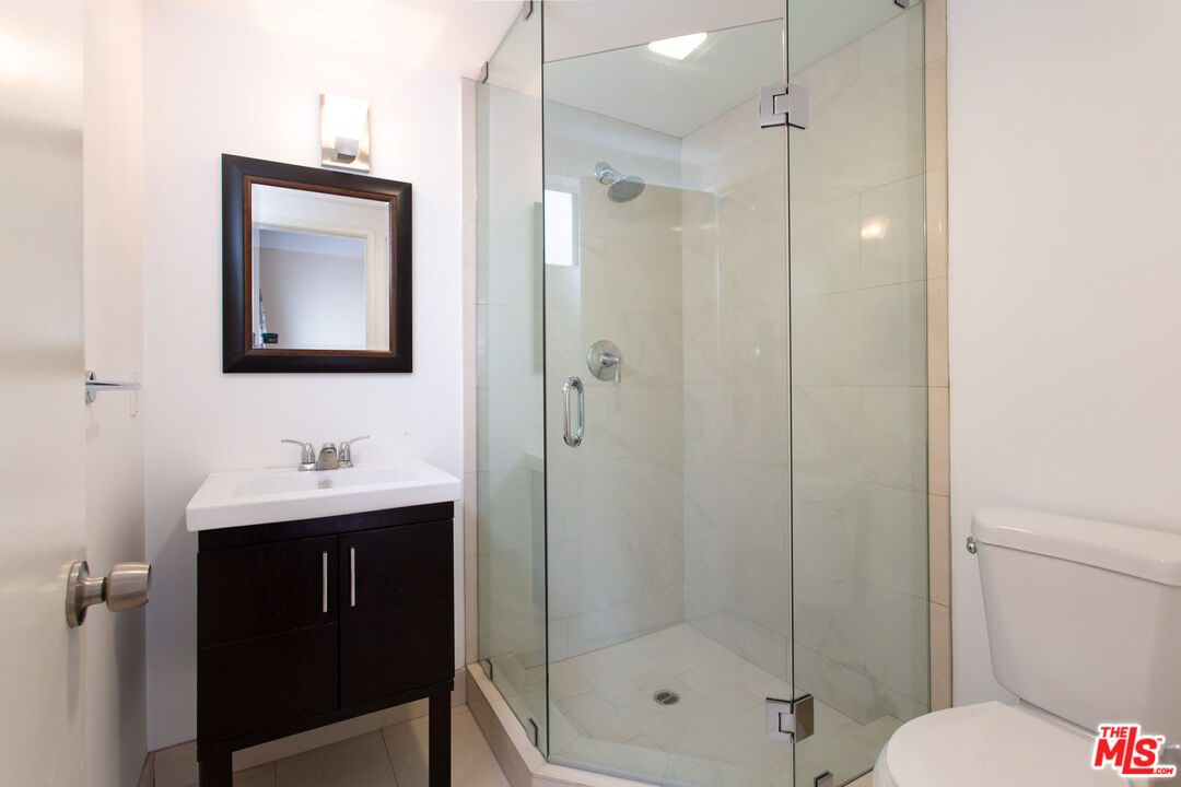 3900 Pacific Avenue Marina del Rey, CA 90292 - Photo 40 of 65 a bathroom with a shower sink mirror and toilet