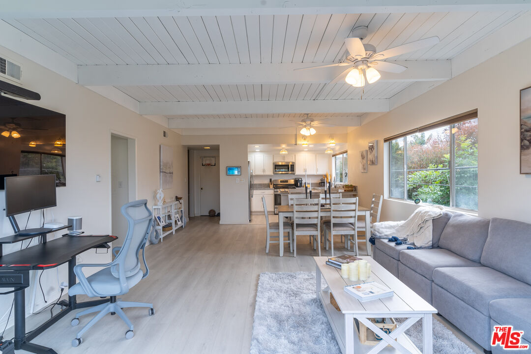 3900 Pacific Avenue Marina del Rey, CA 90292 - Photo 47 of 65 a living room with furniture a chandelier and a dining table