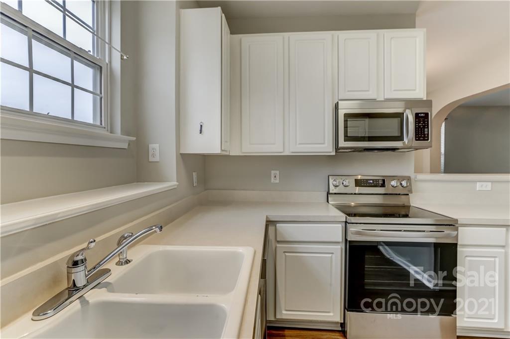 1121 Sienna Sand Way Fort Mill, SC 29708 - Photo 13 of 30 a kitchen with granite countertop a stove and a microwave