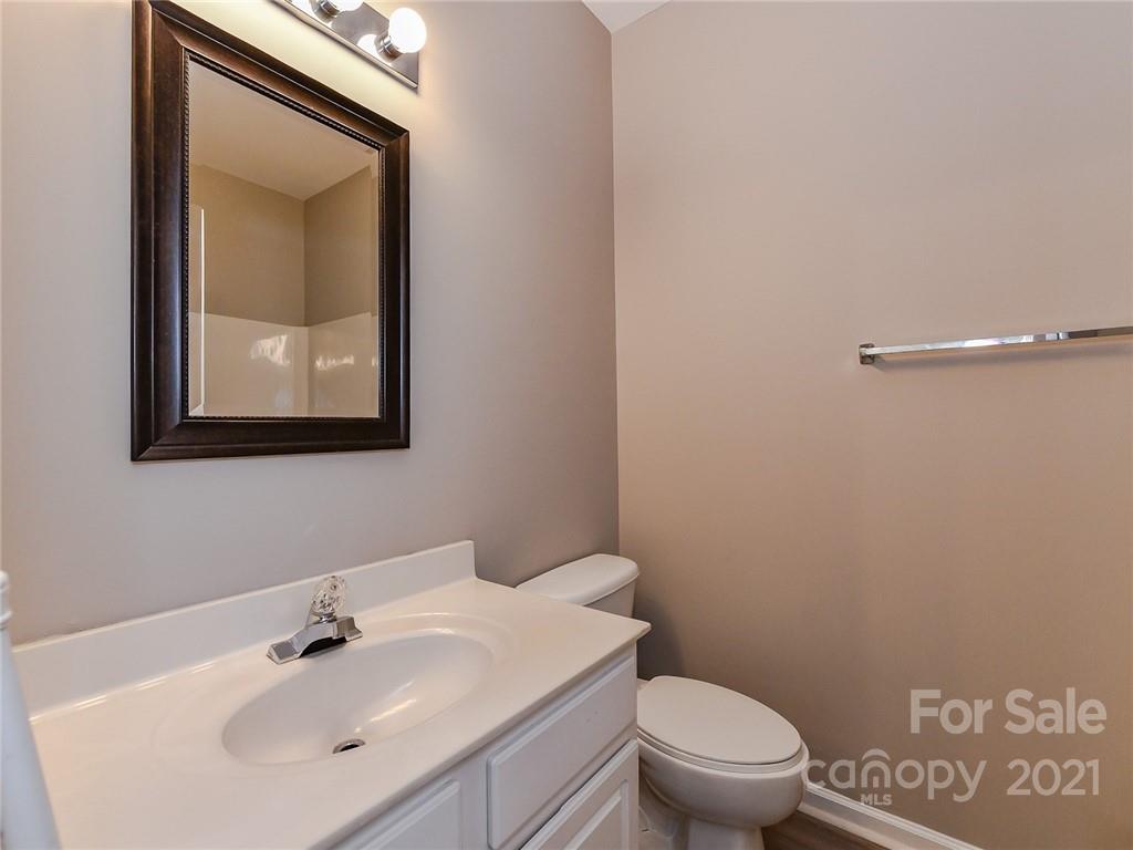 1121 Sienna Sand Way Fort Mill, SC 29708 - Photo 17 of 30 a bathroom with a toilet a sink and mirror