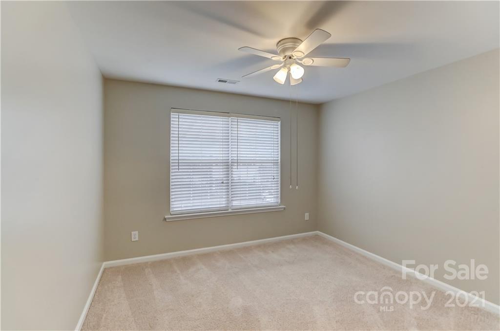 1121 Sienna Sand Way Fort Mill, SC 29708 - Photo 19 of 30 an empty room with windows and fan