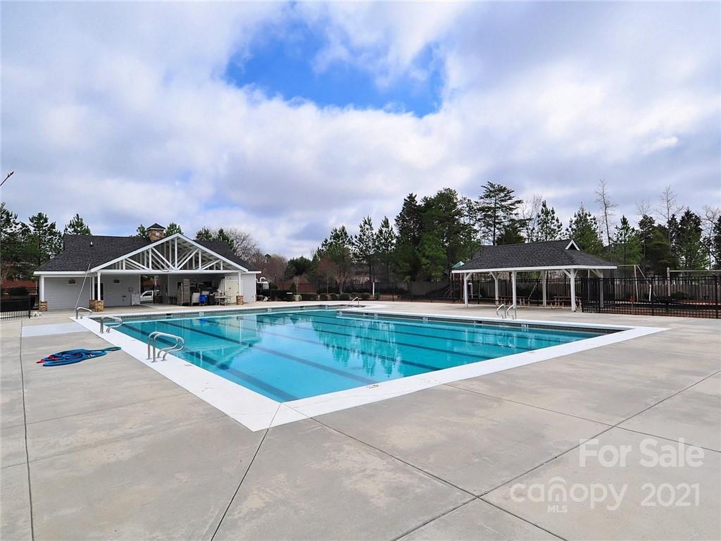 1121 Sienna Sand Way Fort Mill, SC 29708 - Photo 29 of 30 a view of a house with a swimming pool and a yard