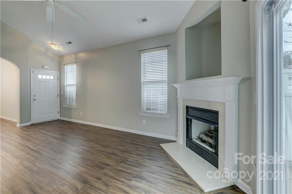 1121 Sienna Sand Way Fort Mill, SC 29708 - Photo 5 of 30 a view of a livingroom with wooden floor and a fireplace