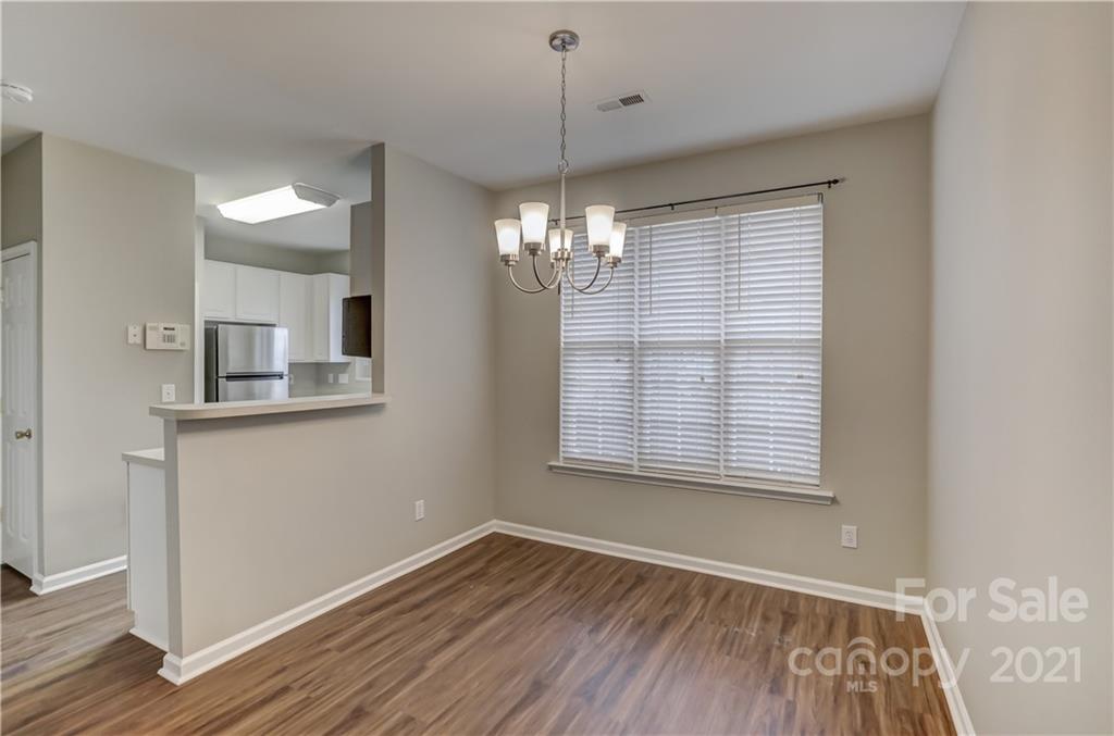 1121 Sienna Sand Way Fort Mill, SC 29708 - Photo 6 of 30 a view of an empty room with wooden floor and a window