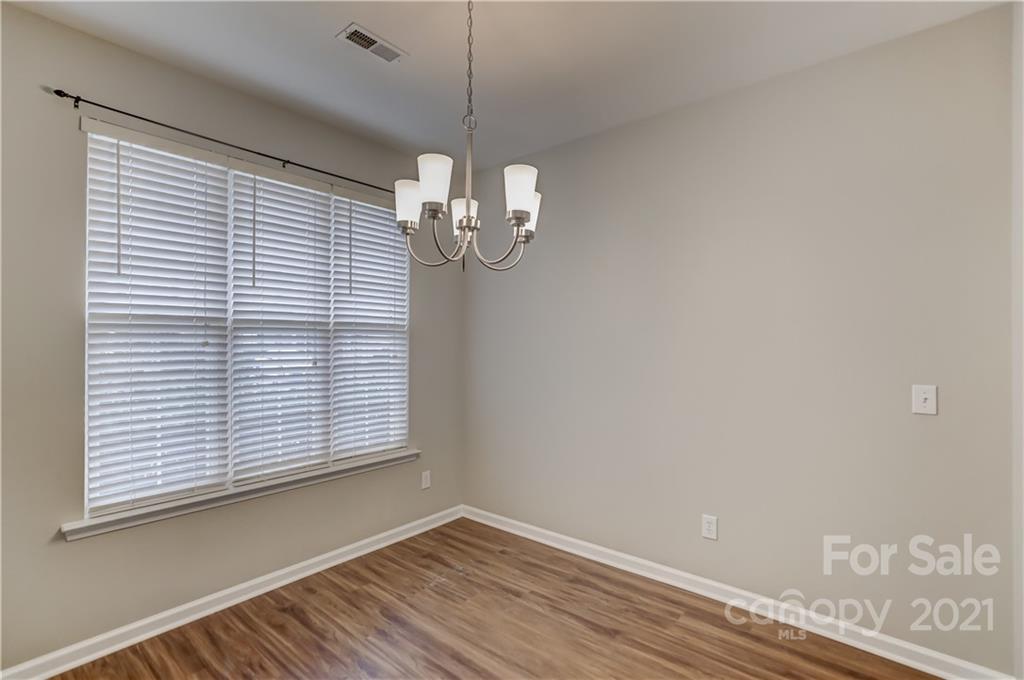1121 Sienna Sand Way Fort Mill, SC 29708 - Photo 7 of 30 an empty room with wooden floor and windows
