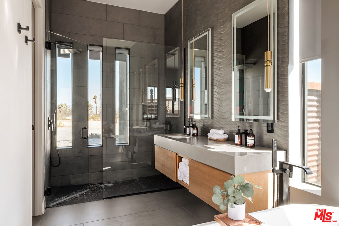 3000 Rockwood Road Joshua Tree, CA 92252 - Photo 22 of 71 a bathroom with a double vanity sink and mirror