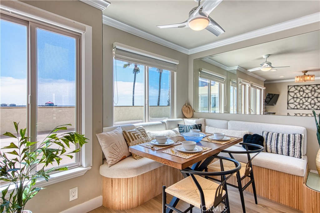 a dining room with furniture a chandelier and wooden floor