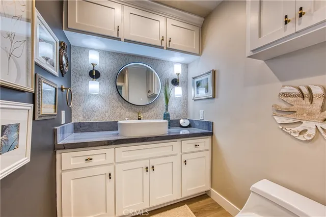 a bathroom with a granite countertop shower and a sink