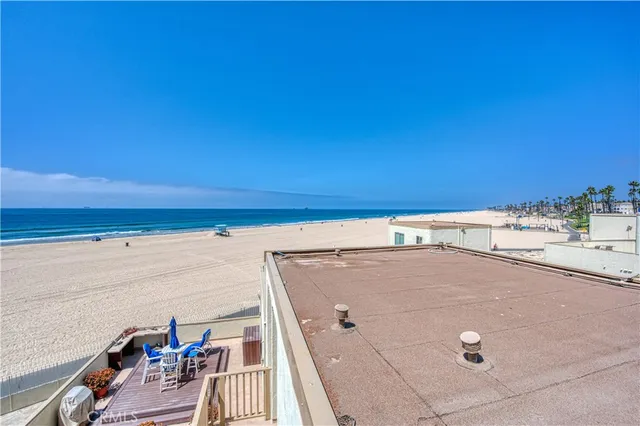 a view of a patio with dining table and chairs under an umbrella