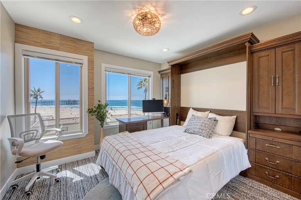 711 Pacific Coast Highway, Unit 421 Huntington Beach, CA 92648 - Photo 25 of 35 a bedroom with a bed and a large window with outer view