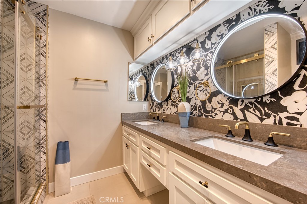 711 Pacific Coast Highway, Unit 421 Huntington Beach, CA 92648 - Photo 35 of 35 a bathroom with a sink and mirror