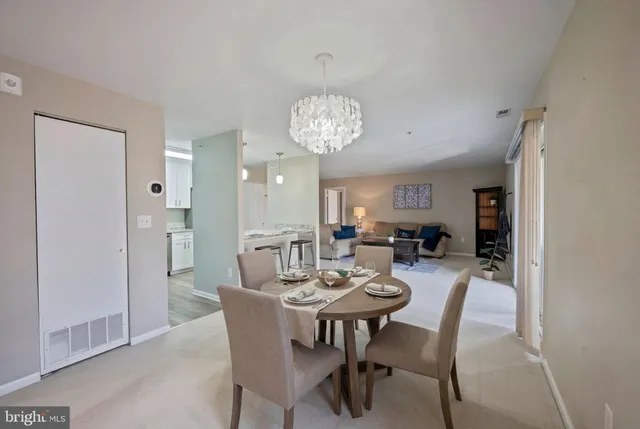 a view of a dining room with furniture and a chandelier