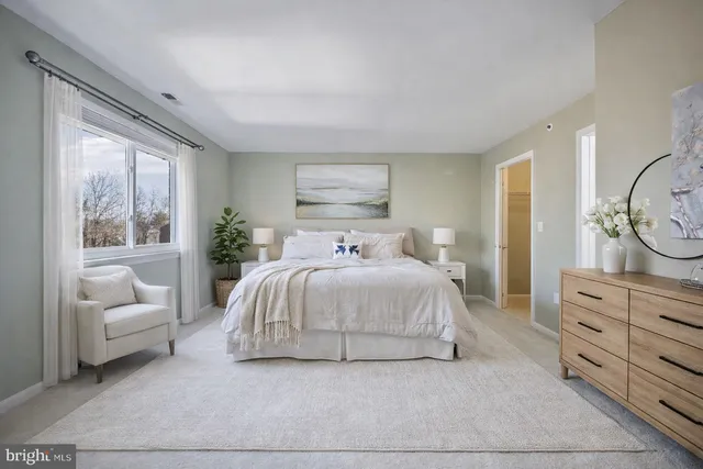 a bedroom with a bed and a couch