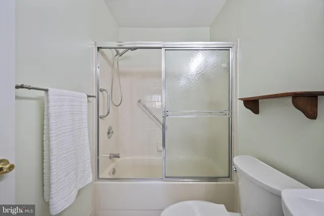 a bathroom with a shower and a toilet
