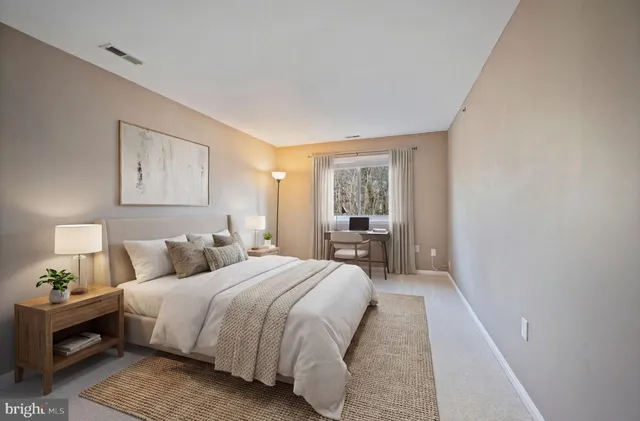 a bedroom with a bed and a lamp