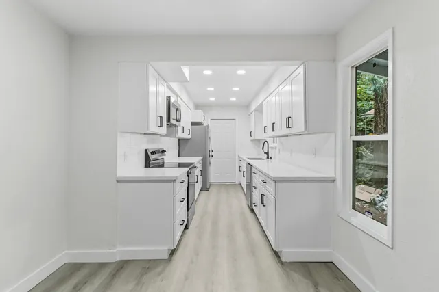 a view of a kitchen with electric appliances
