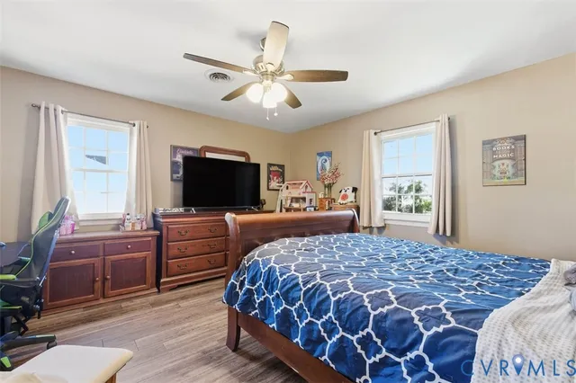 a bedroom with a large bed and a flat screen tv