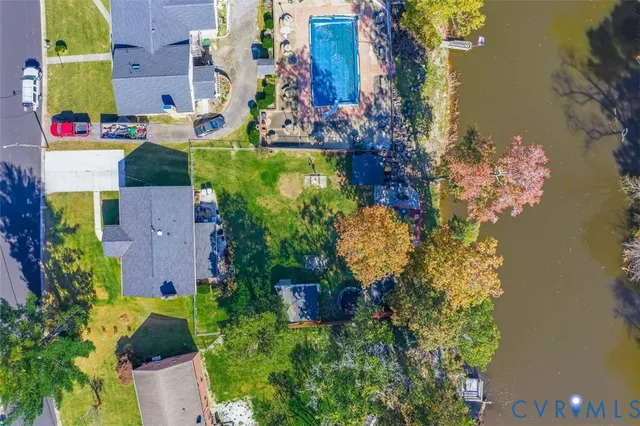 an aerial view of a house with a yard and garden